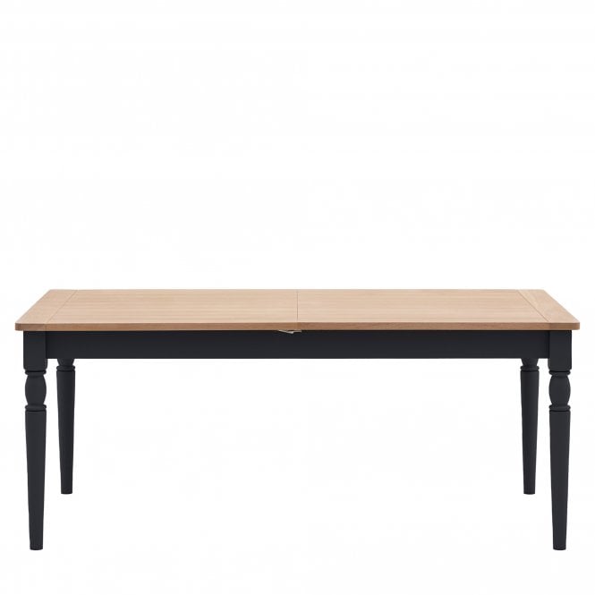 Gallery Direct Eton Extending Dining Table in Meteor features an oak wood table top and painted frame and spindle legs