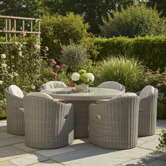 The Gallery Garden Ragusa 6 Seater Dining Set features six poly rattan weave chairs with premium thick cushions, and a matching glass top round dining table