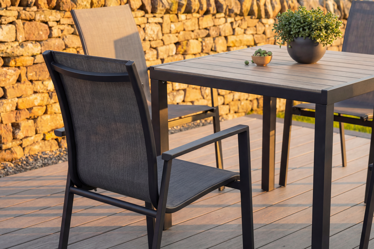 The Royal Garden Catala 4 Seat Square Dining Set features a square table with a wood-effect grooved top and aluminium frame, and 4 aluminium and textilene stacking chairs