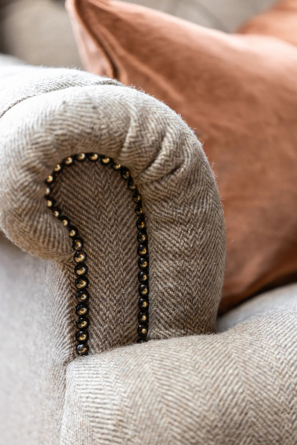 Tetrad Arbroath Snuggler Sofa in Jura Stag Harris Tweed upholstery in neutral tones, with scrolled arms and stud detailing