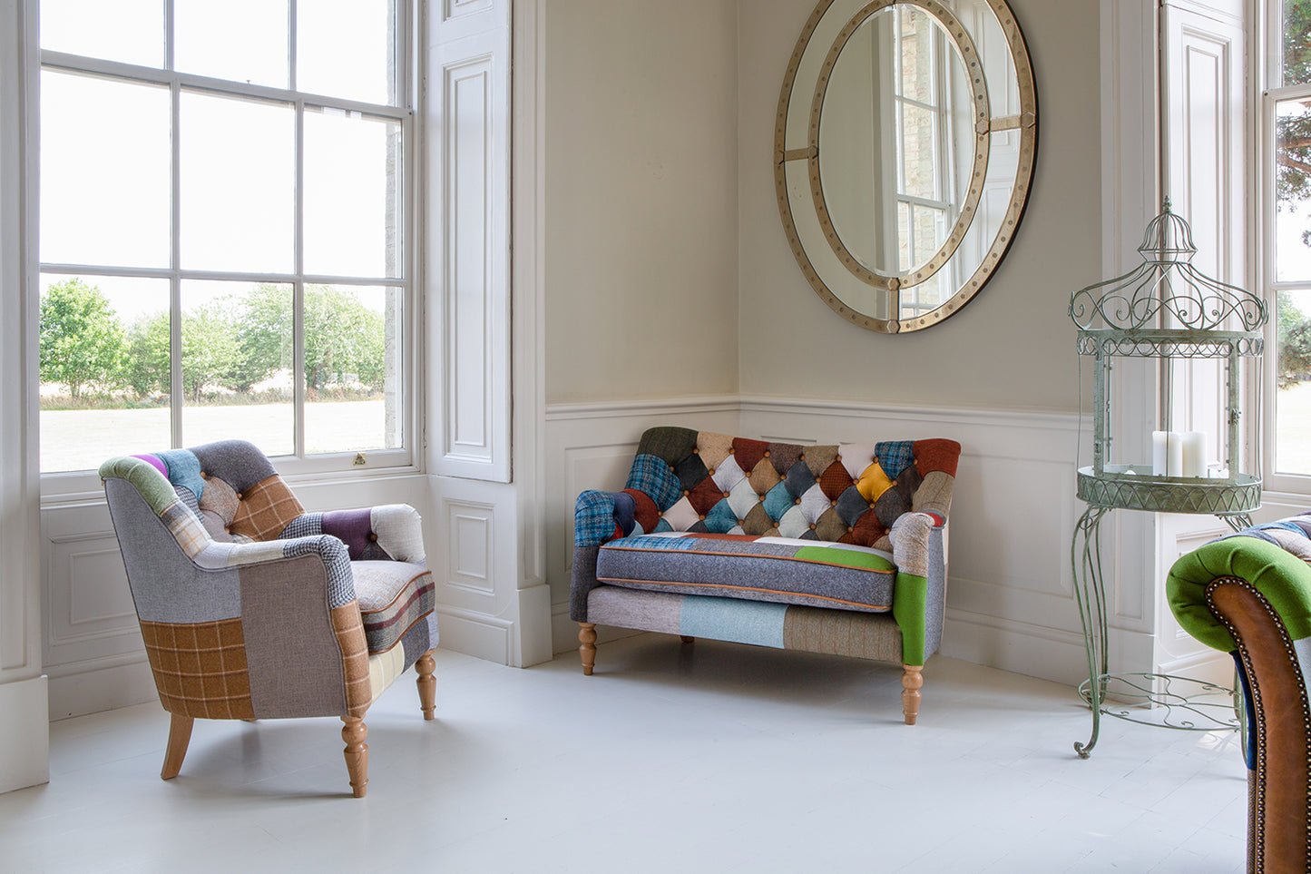 Vintage Sofa Company Alsace Patchwork Petit Sofa features a deep buttoned back, a padded seat cushion with leather trim, and wooden legs