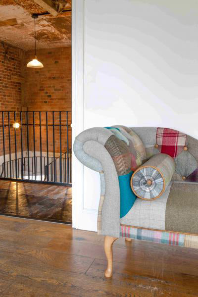Vintage Sofa Company Chester Chaise Sofa in Patchwork upholstery with one scrolled arm, bolster cushion and light wooden legs