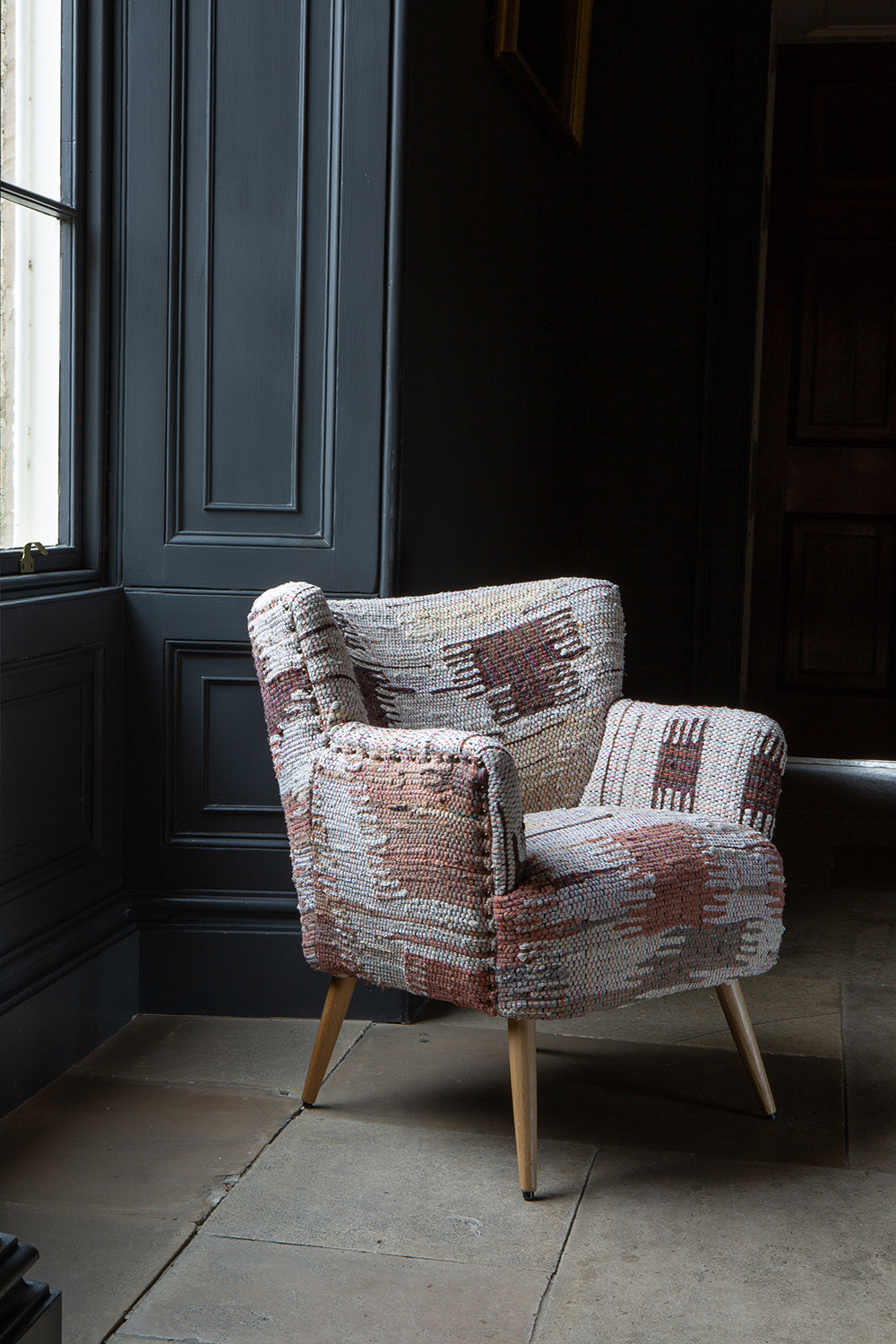 Vintage Sofa Company Hansi Chair features a chunky woven fabric finish in soft muted tones, with gently curved arms and back for a comfortable and supportive seat