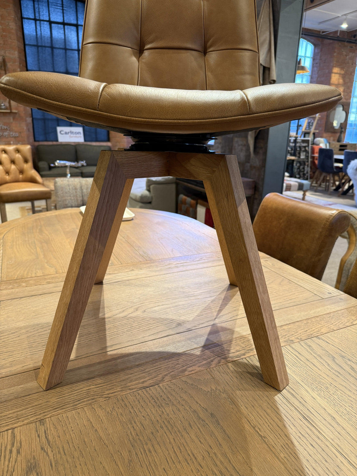 Carlton Furniture Pair of Atlanta Swivel Chairs - Tan Leather - Grey Oiled Legs — swivel seat and wooden leg detail