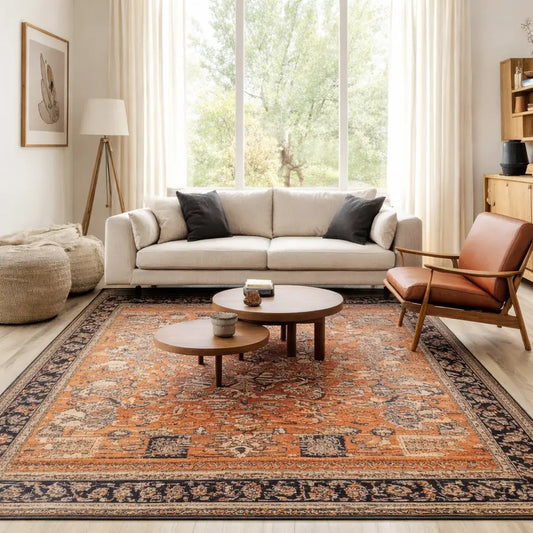 Cosy living space with beige sofa, round coffee tables and statement rug
