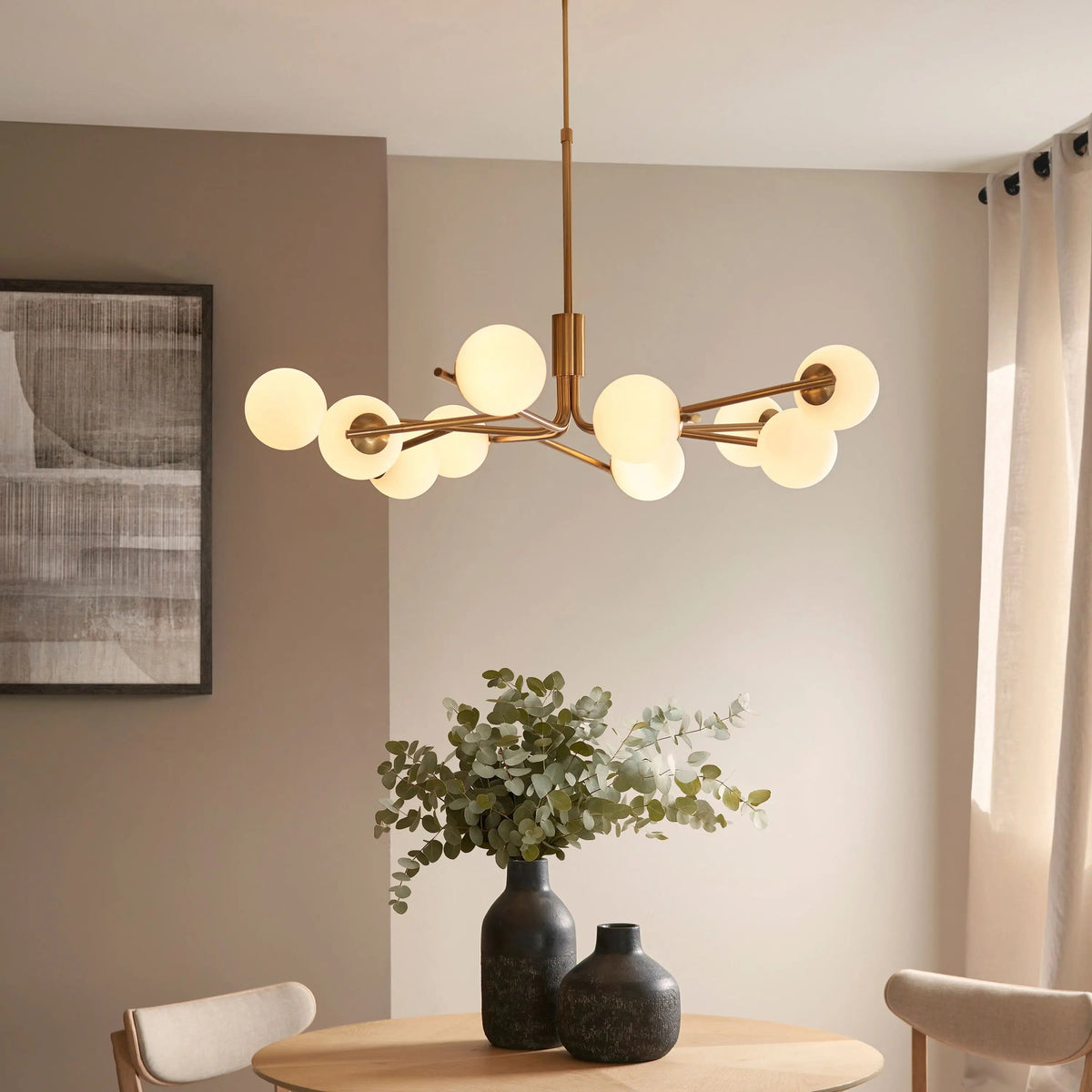 Gallery Direct Aaron 10 Pendant Light Brushed Aged Brass, styled above a dining table in a neutral interior