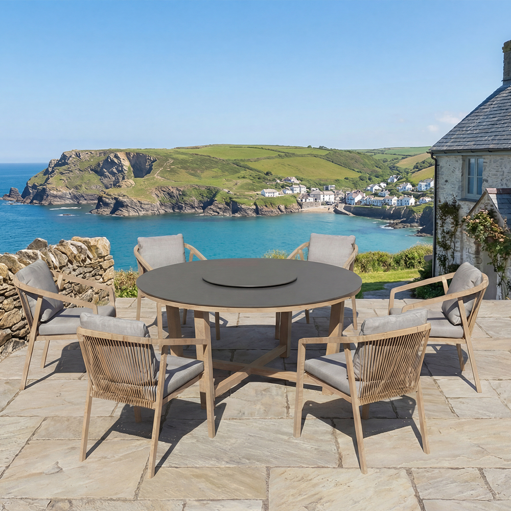 The Royal Garden Kanto 6 Seater Round Dining Set features 6 rope detailed chairs with padded grey cushions and a dark grey round table with light wood frame