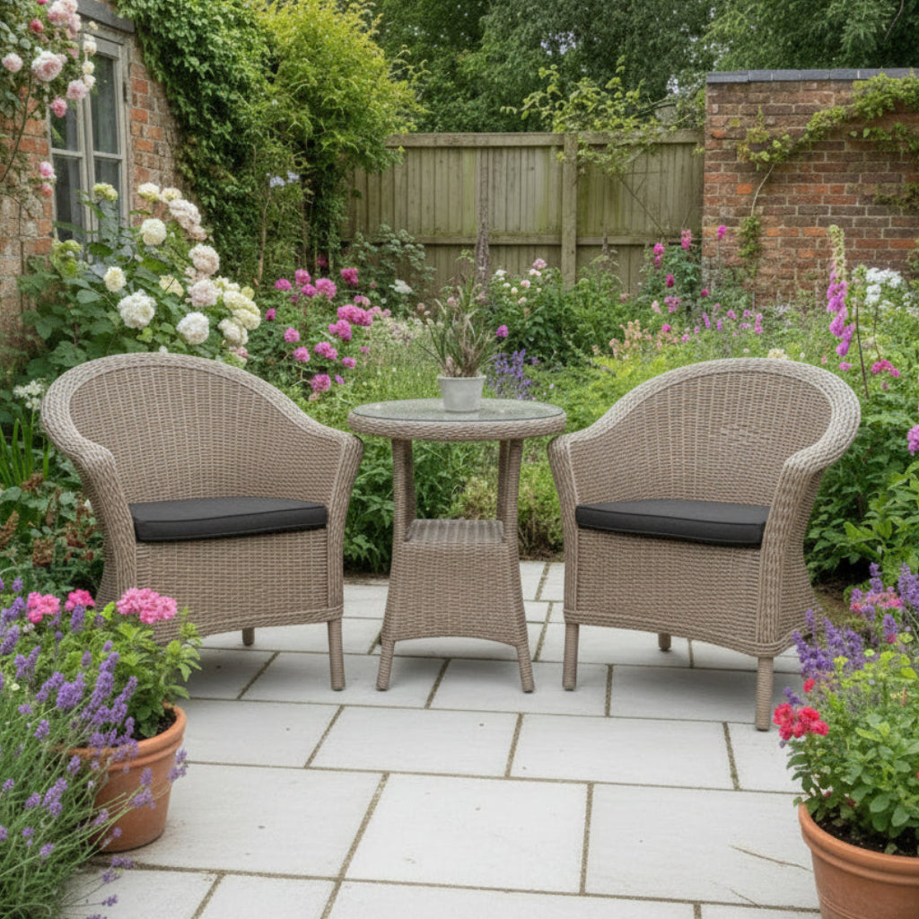 4 Seasons Outdoor Chester Penida Bistro Set in Pure Weave material, features 2 armchairs with seat pads and a glass top bistro table with a lower shelf
