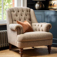 Tetrad Arbroath Chair in Jura Stag Harris Tweed neutral fabric, with deep button tufting, scrolled arms and stud detailing, and dark wooden legs