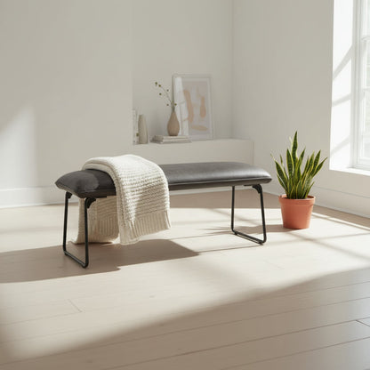 The Baker Cooper Low Bench in Grey padded faux leather upholstery and black metal tubular legs, can seat up to 2 people and matches the Cooper corner bench collection