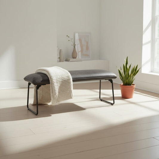The Baker Cooper Low Bench in Grey padded faux leather upholstery and black metal tubular legs, can seat up to 2 people and matches the Cooper corner bench collection