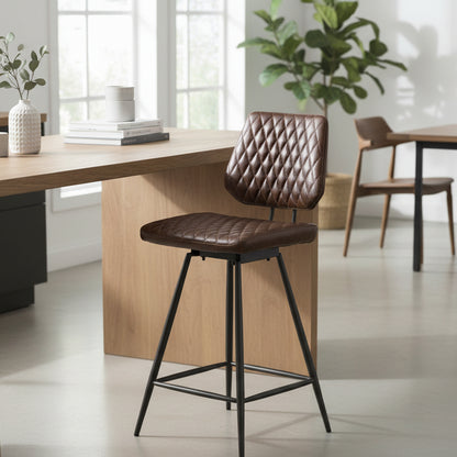 Baker Dalton Bar Chair is upholstered in Brown faux leather with diamond stitch quilted design and powder coated aluminium legs. Also features a 180 degree swivel seat function 