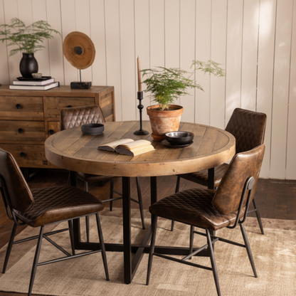 The Baker Nixon 120cm Round Dining Table can seat up to 4 people and is crafted from reclaimed timber for a unique look to each piece, with metal cross legs.