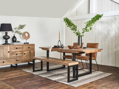Baker Nixon 140cm-180cm Extending Dining Table seats 4-8 people and features a reclaimed wood table top with black metal U shaped legs