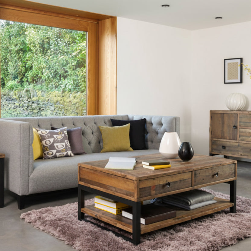 Baker Nixon Coffee Table is crafted from reclaimed wood and features 2 drawers and a lower shelf, with a black metal frame