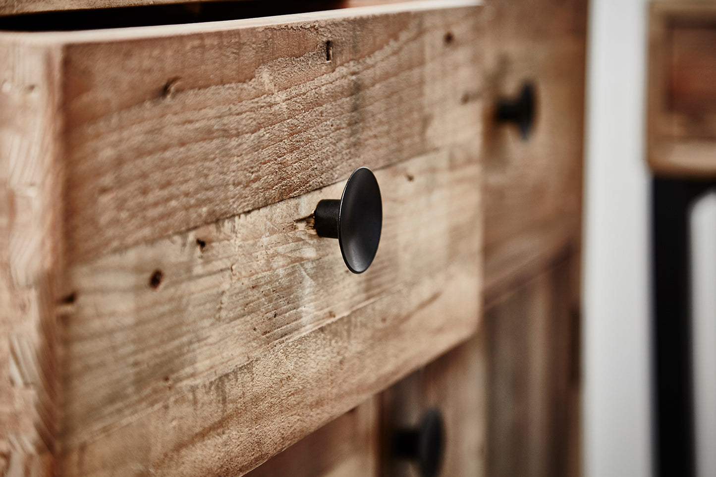 Baker Nixon Wide Sideboard is crafted from pieces of reclaimed wood for a rustic feel, with black metal drawer knobs and framework
