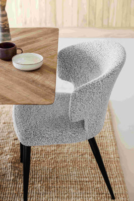 The Baker Belle Dining Chairs in Grey Boucle textured upholstery with curved backrest, and black powder coated legs