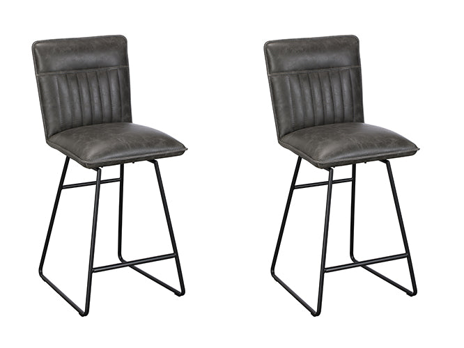 The Baker Cooper pair of Bar Chairs are upholstered in a distressed Grey faux leather material with a car seat inspired stitched design, and black metal tubular legs