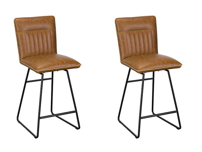 Baker Pair of Cooper Bar Chairs upholstered in Tan coloured padded faux leather with car seat inspired stitching on the back rest, and black tubular metal legs