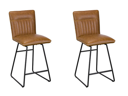 Baker Pair of Cooper Bar Chairs upholstered in Tan coloured padded faux leather with car seat inspired stitching on the back rest, and black tubular metal legs