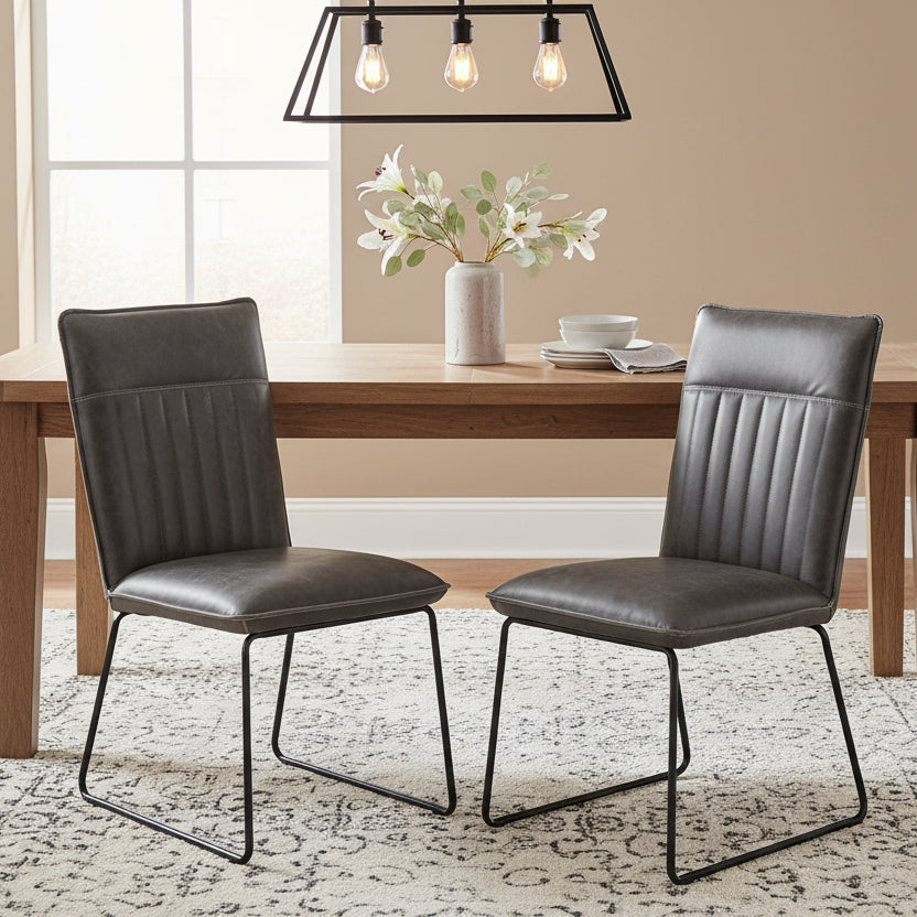 Baker Pair of Cooper Dining Chairs in Grey mottled faux leather with stitched design to the backrest, with back powder coated metal legs