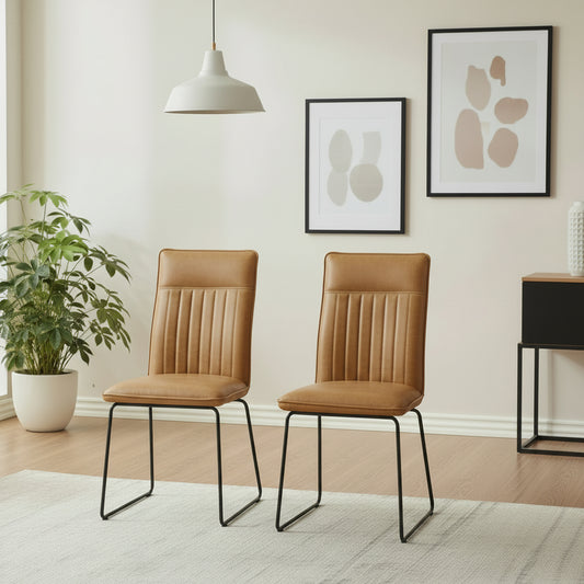 Baker Pair of Cooper Dining Chairs in Tan faux leather with a car seat inspired stitched design and black metal legs