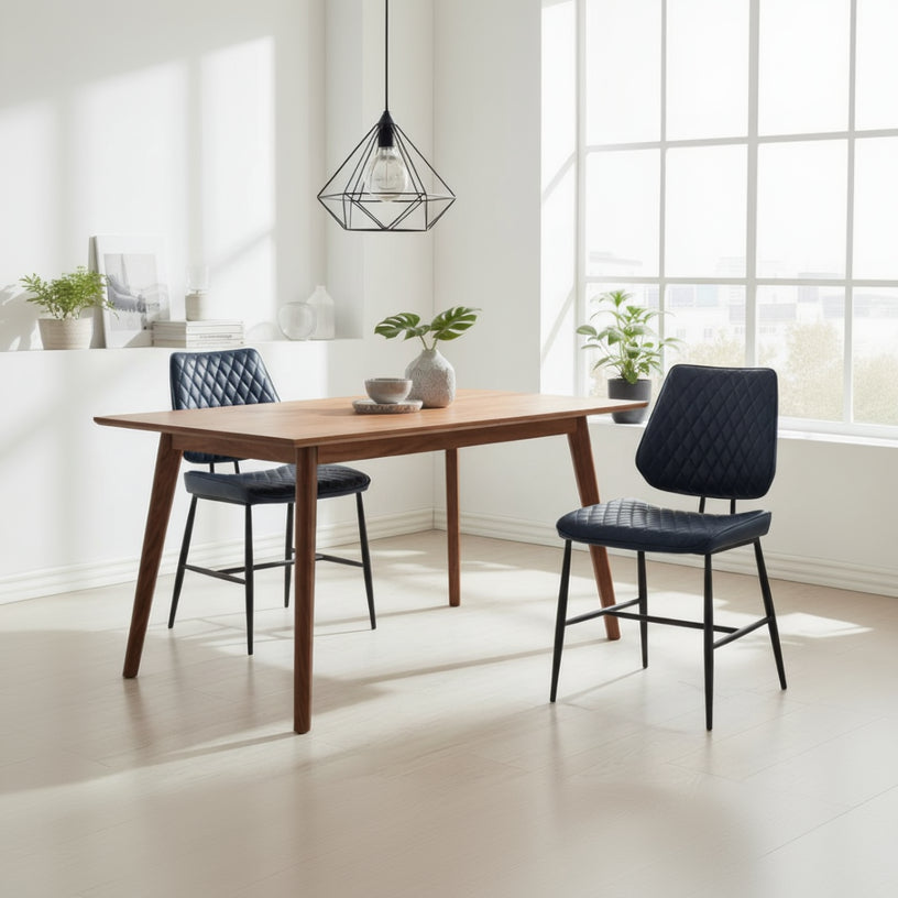 The Baker Pair of Dalton Dining Chairs are upholstered in a Dark Blue PU leather, with a diamond stitch design and black metal frame and legs