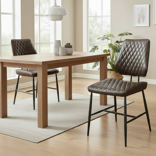 The Baker Pair of Dark Brown Dalton Dining Chairs are upholstered in a PU leather with diamond stitched design, and black metal tubular legs and frame