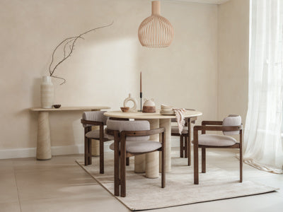 The Baker Pair of Grace Dining Chairs are upholstered in a boucle natural beige colour fabric, with a dark wooden 3 legged frame