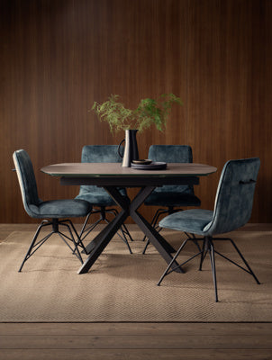 Baker Pair of Lola Swivel Dining Chairs upholstered in a Teal coloured poly velvet fabric, with black powder coated aluminium legs