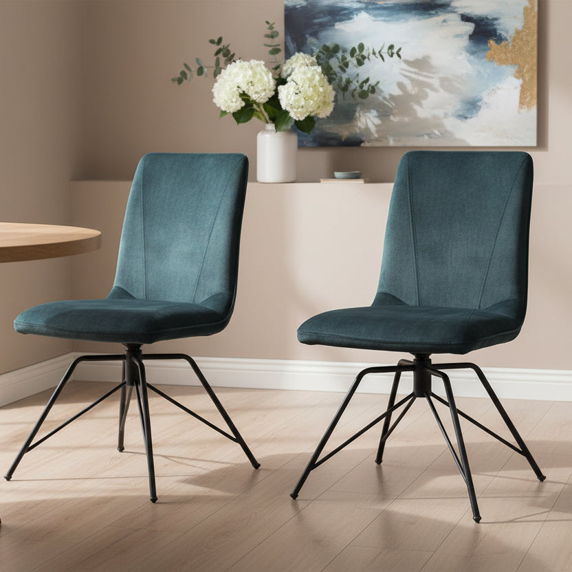 Baker Pair of Lola Dining Chairs with 180 degree swivel seat, fully upholstered in a padded Teal coloured, velvet effect material, with black metal legs