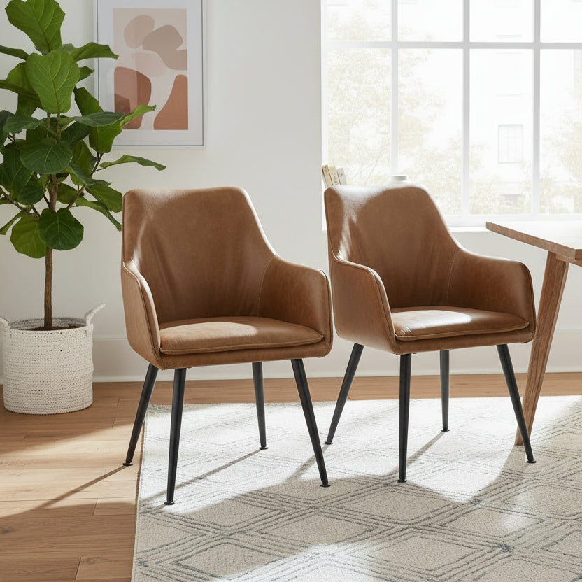Baker Pair of Oliver Arm Chairs upholstered in a Tan faux leather with black powder coated aluminium legs