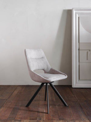The Baker Paige Dining Chair in a Light Grey poly velvet effect upholstery features a cut out back and black powder coated aluminium legs 