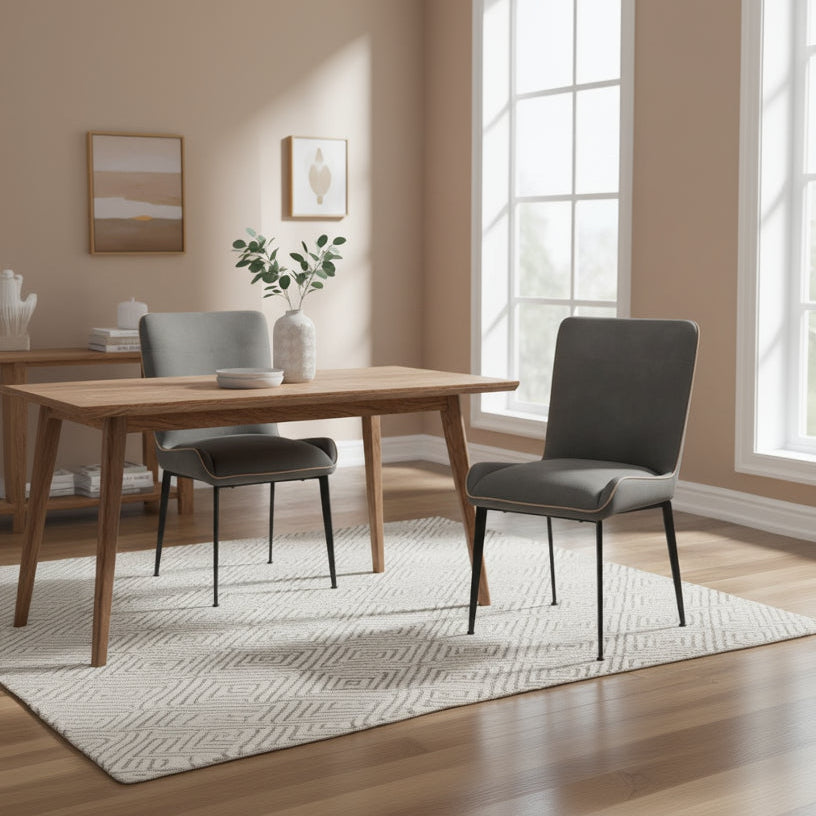 Baker Pair of Rebecca Dining Chairs with a generously padded wrap up seat design, fully upholstered in Anthracite grey coloured PU fabric, with black powder coated metal legs