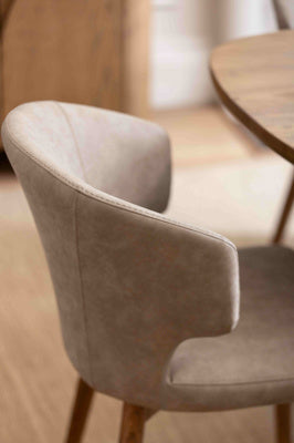 Baker Pair of Rowan Dining Chairs features an upholstered faux leather curved backrest in a light brown colour, and tapered wood-effect legs