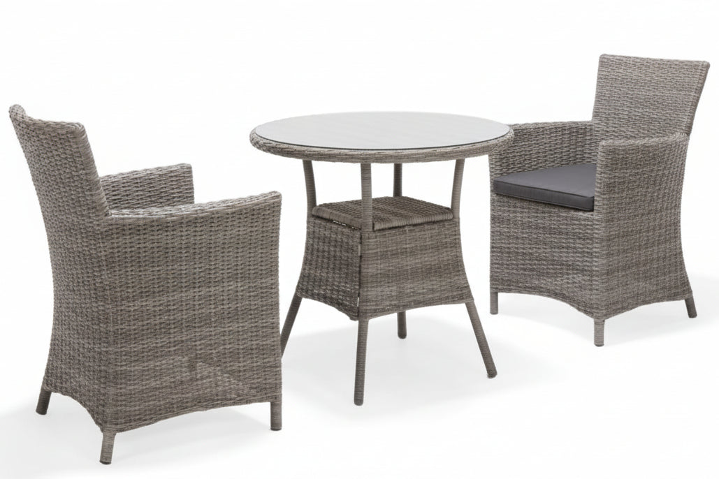 The Bermuda bistro set made from a synthetic rattan for durability has a round glass top bistro table and 2 armchairs with seat pads, in Grey