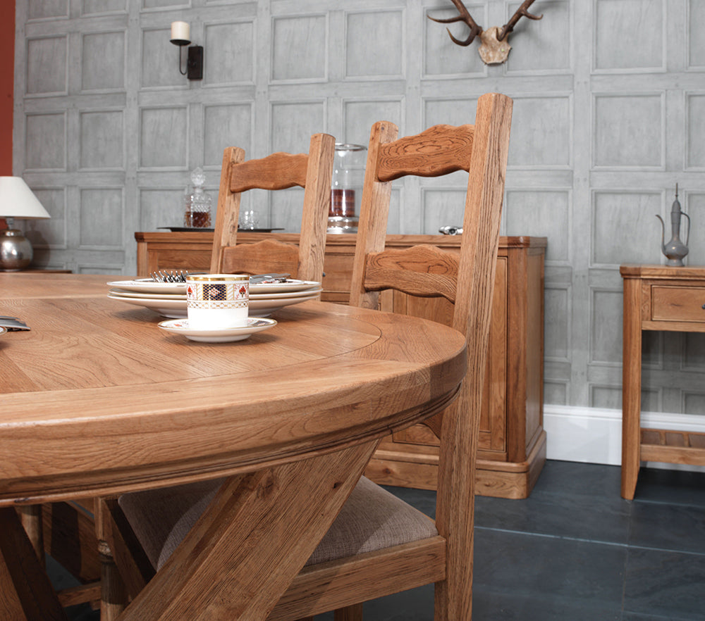 Carlton Furniture Copeland 1800 Cross Leg Oval Extending Dining Table features a chunky solid oak oval table top that can accommodate 8-12 people when extended