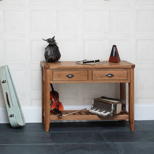 Carlton Furniture Copeland Console Table features 2 drawers with metal handles and a lower storage shelf, constructed from natural solid oak wood