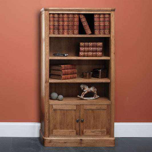 Carlton Furniture Copeland Tall Bookcase with 4 shelves and lower cupboard doors for additional storage, crafted from solid oak wood