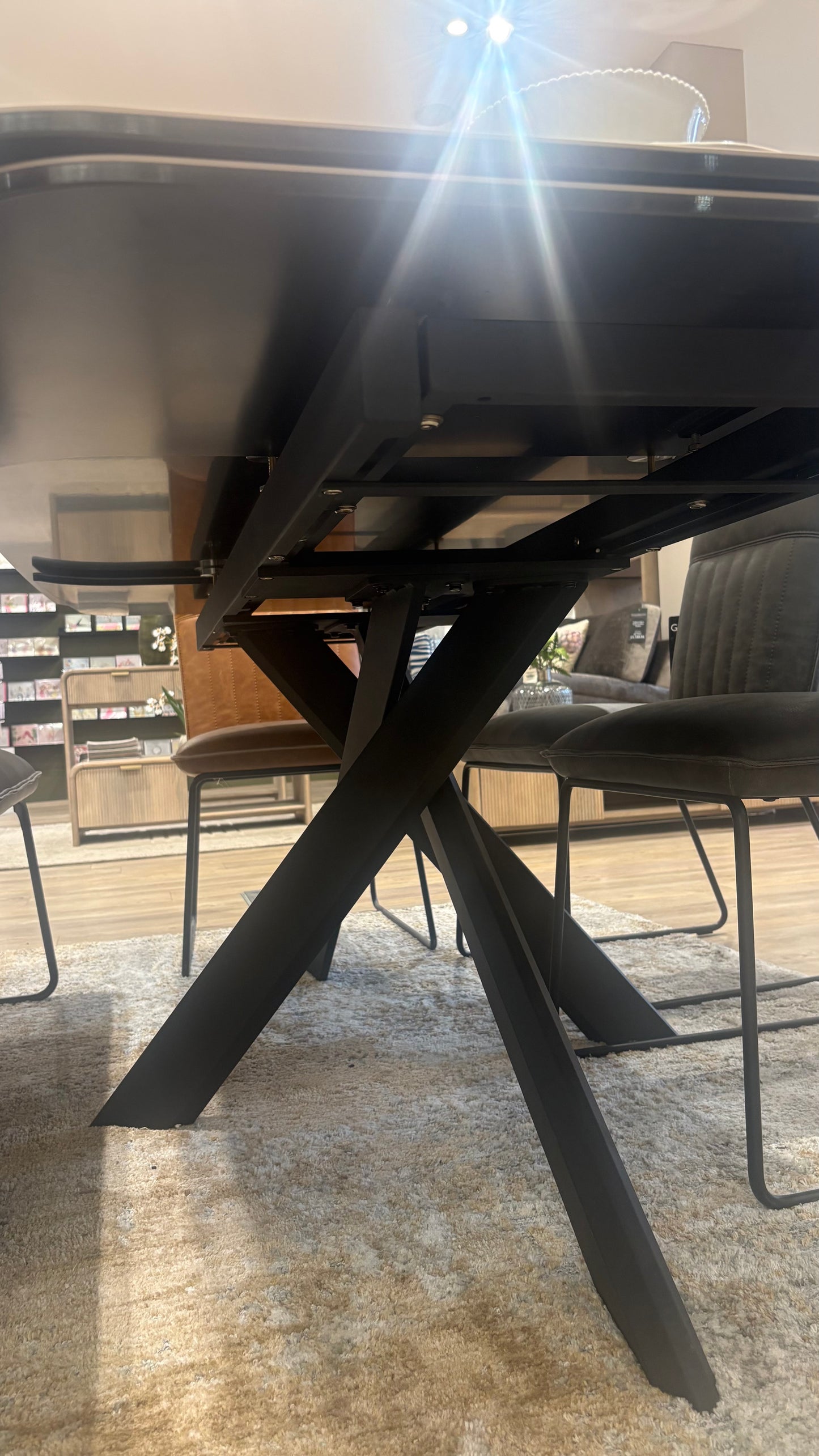 Carlton Furniture Florence Extending Oval Dining Table with black metal spider leg base