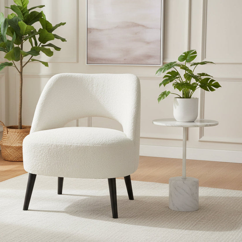 Carlton Furniture Lydia Accent Chair Upholstered in an Ivory Boucle effect fabric, the back rest has a cut-out design, the seat is well padded for comfort and the dark wood legs contrast against the Ivory fabric
