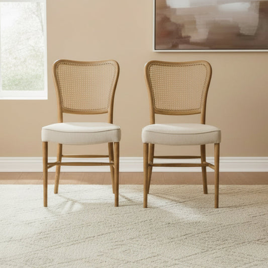 Carlton Furniture Pair of Anouk Dining Chairs with Woven Rattan Back rest and a natural coloured linen cushioned seat within a warm wooden frame