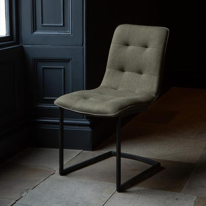 Carlton Furniture Hampton Dining Chairs Upholstered in a Hunter Green Coloured Fabric with button tufting and black metal cantilever legs
