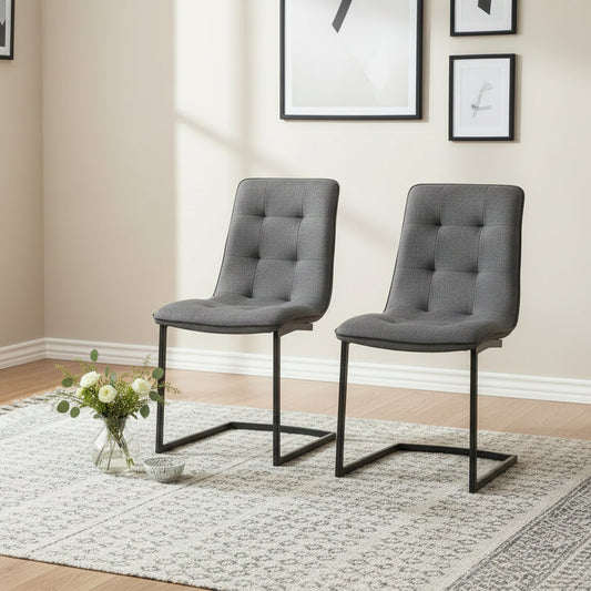 Carlton Furniture Pair of Hampton Dining Chairs in Pewter coloured fabric with button tufted detail and a black cantilever style base