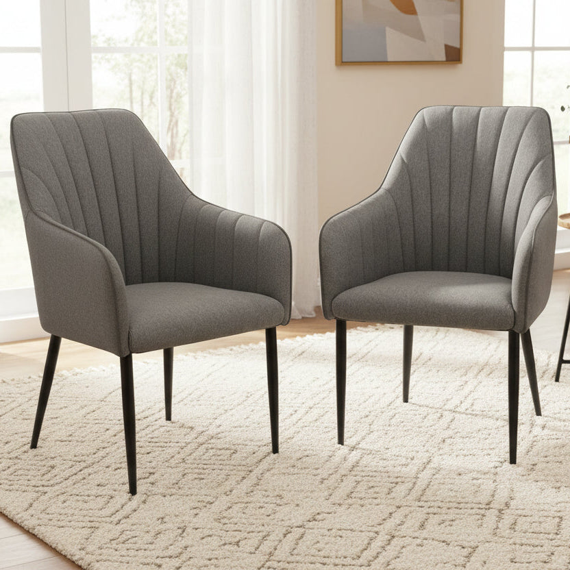 Carlton Furniture Pair of Oliver Dining Chairs Upholstered in a Pewter Coloured Fabric, with vertical stitched design and black metal legs