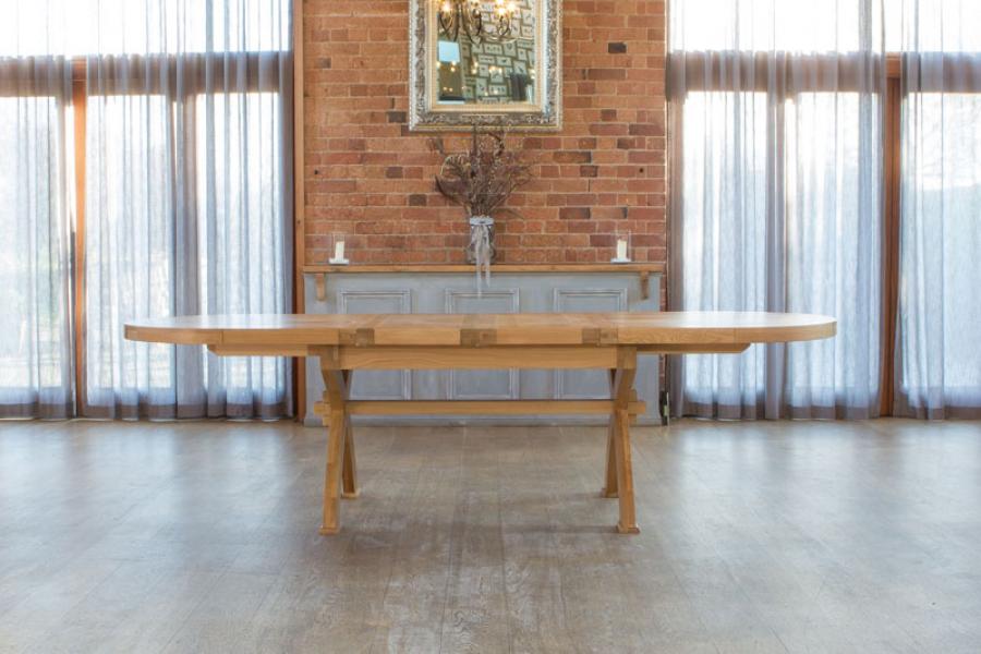 Carlton Furniture Windermere Oval cross-Leg Extending Dining Table crafted from solid natural oak