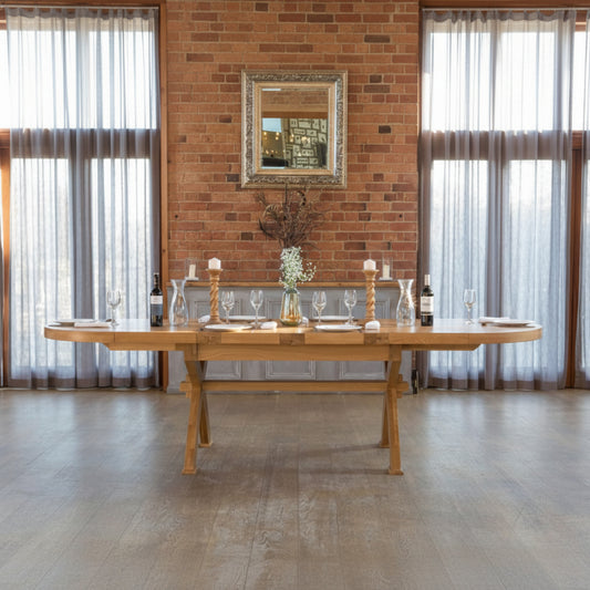 Carlton Furniture Windermere Oval Extending Dining Table with cross leg base, crafted from solid natural oak, this table can seat 8-12 people when extended