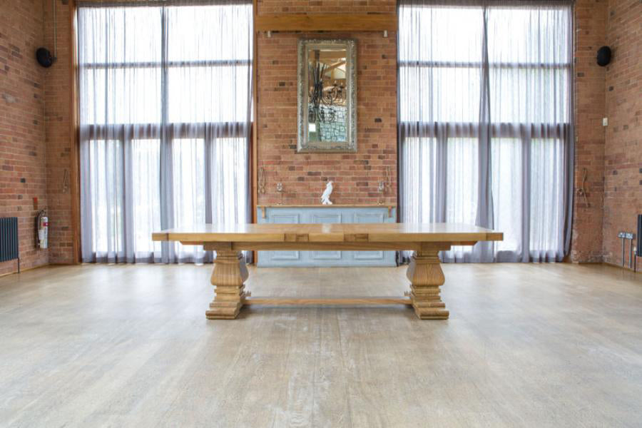 Carlton Furniture Windermere Rustic Monastery Extending Dining Table in Natural with chunky pedestal legs and a thick solid oak table top