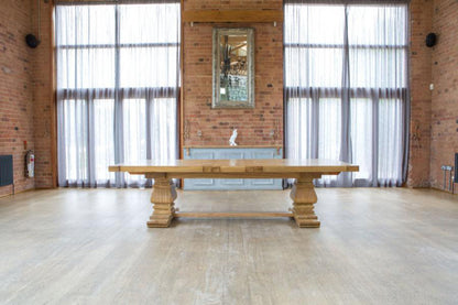 Carlton Furniture Windermere Rustic Monastery Extending Dining Table in Natural with chunky pedestal legs and a thick solid oak table top
