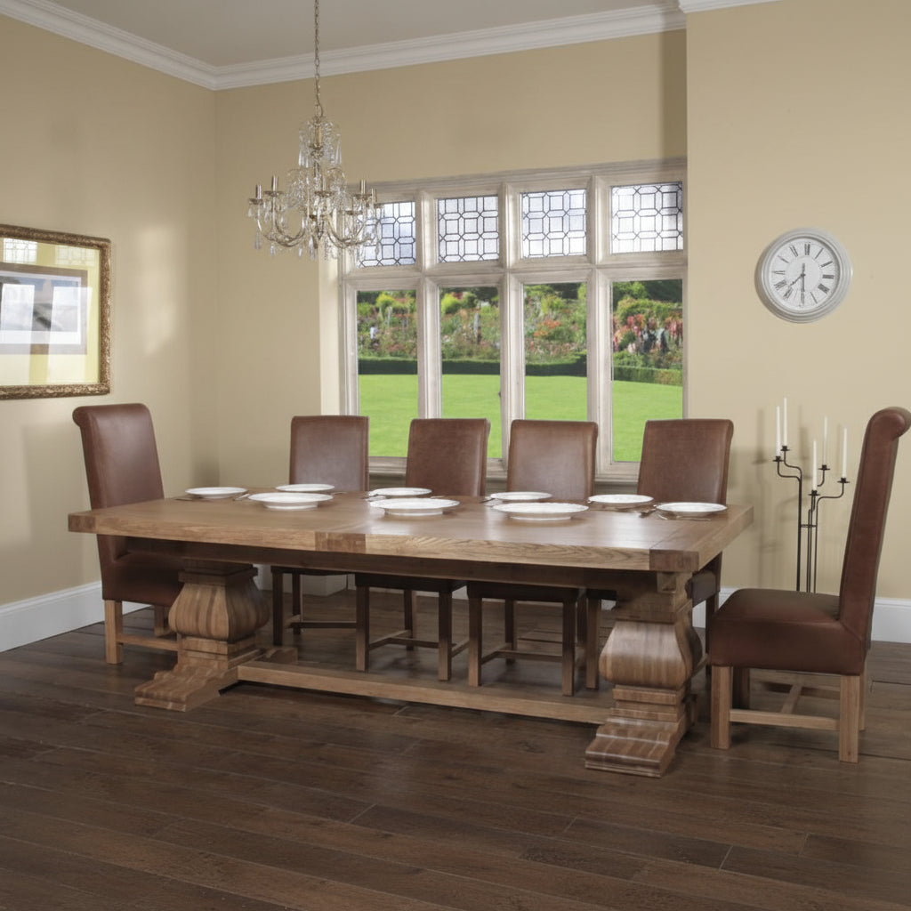 Carlton Furniture Windermere Rustic Monastery Extending Dining Table in Natural Oak features a solid thick table top, with chunky pedestal legs. The table can seat 8-10 when closed or 12-14 plus when fully extended